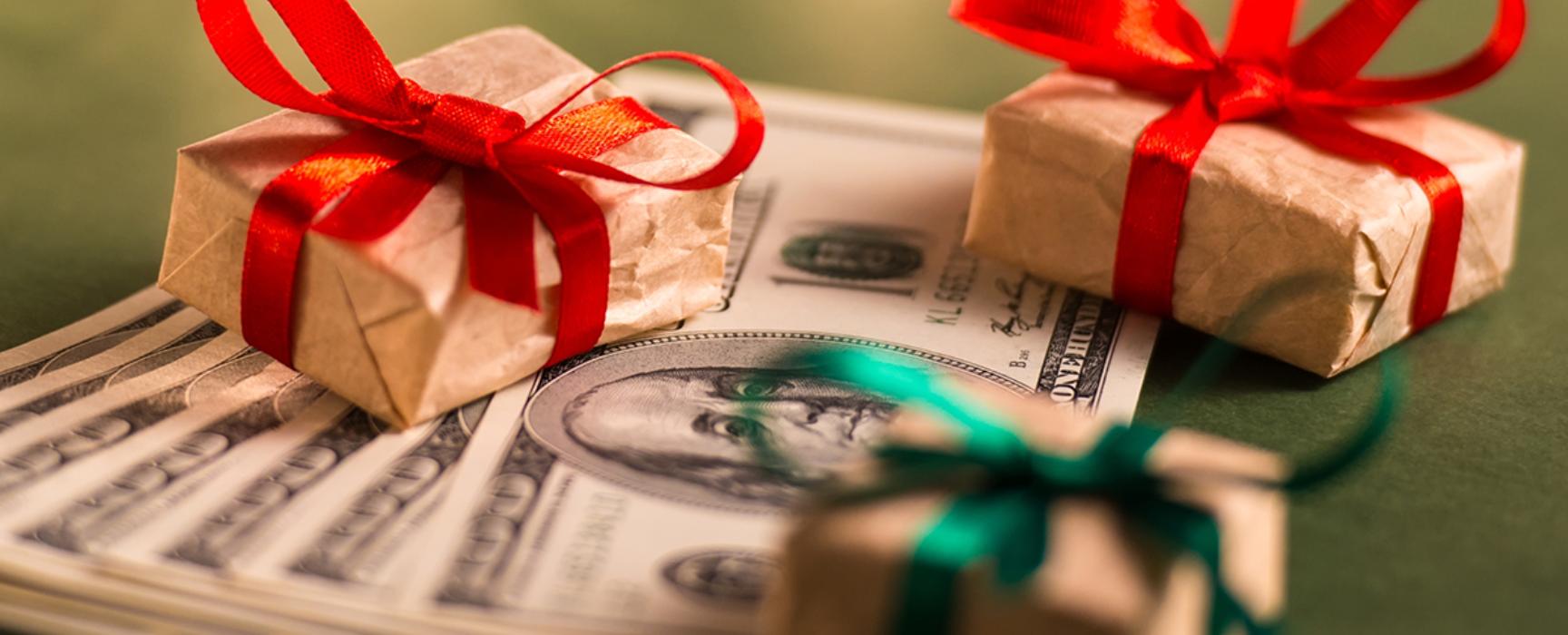 little gift packages next to a stack of cash
