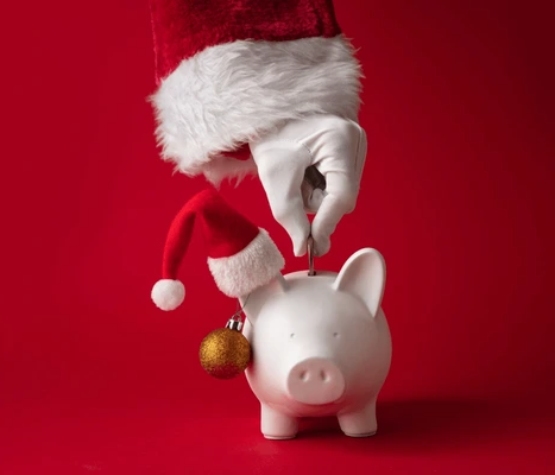 Santa Claus putting money in a piggy bank