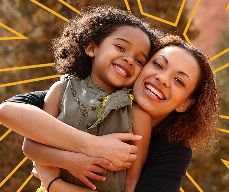 Mother and child hugging and smiling