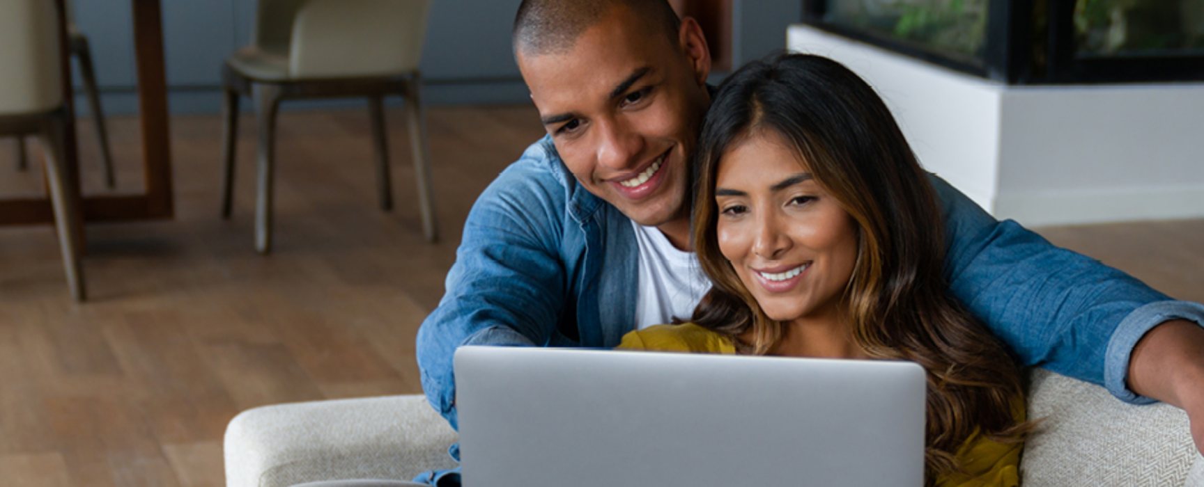 a couple looking at their laptop computer