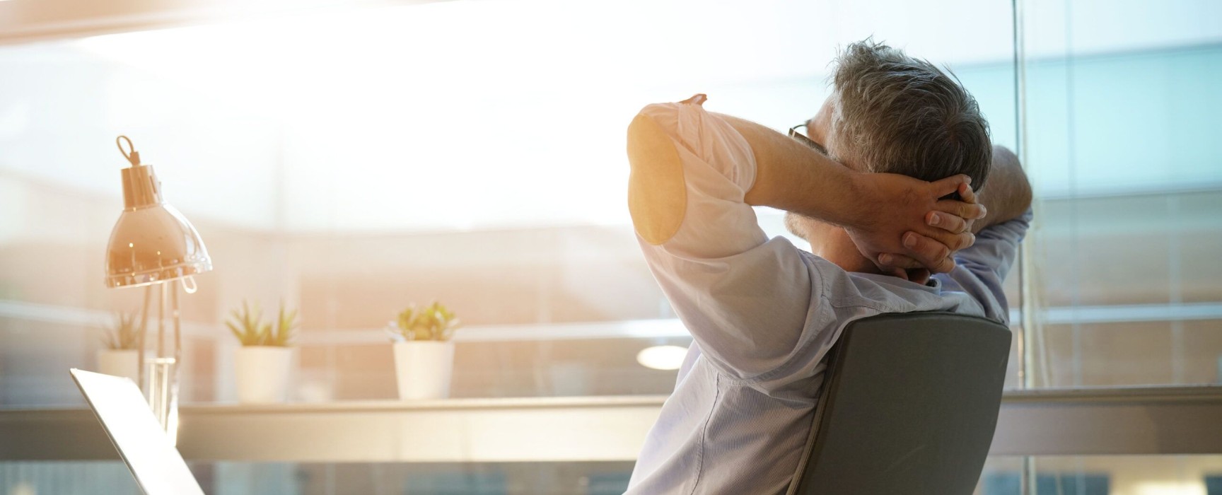 a man sitting back in his office chair